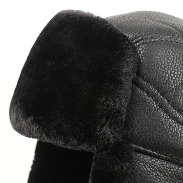 Close-up of a black leather helmet with fur lining on a white background