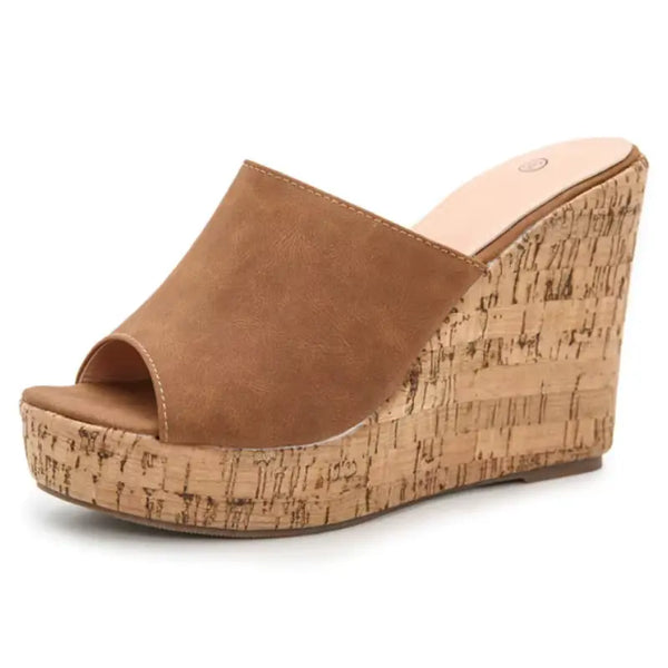 Brown wedge sandal with cork wedge sole on a white background